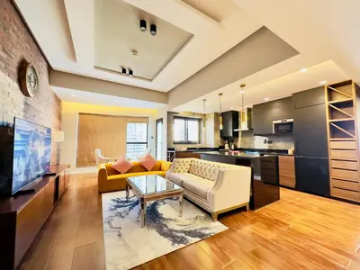 a large living room with a couch and a table at Sea Front Living, Upgraded 2BR Apartment, Escan Tower, Dubai Marina in Dubai