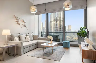 a living room with a couch and a large window at FIRST CLASS 1BR Burj Khalifa & Fountain Views in Dubai