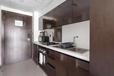 a kitchen with a sink and a stove top oven at Spacious Studio in Business Bay in Dubai