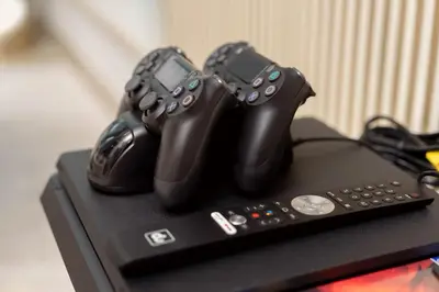 two video game controllers sitting on top of a table at Elite Royal Apartment - Full Burj Khalifa & Fountain View - Luxury Edition - Strategos in Dubai
