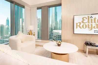 a living room with a white couch and a table at Elite Royal Apartment - Full Burj Khalifa & Fountain View - Luxury Edition - Strategos in Dubai