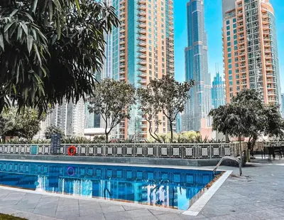 a swimming pool in a city with tall buildings at Elite Royal Apartment - Full Burj Khalifa & Fountain View - Luxury Edition - Strategos in Dubai