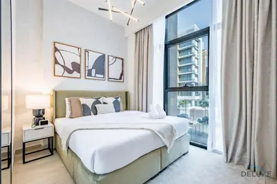 a bedroom with a bed and a large window at Captivating 1BR Apartment in Azizi Riviera 20, Al Merkadh by Deluxe Holiday Homes in Dubai