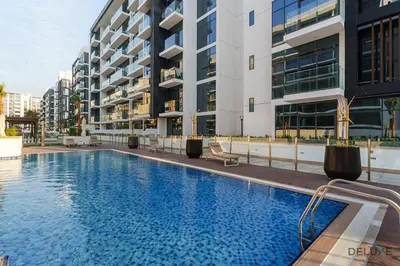 a large swimming pool in front of a building at Captivating 1BR Apartment in Azizi Riviera 20, Al Merkadh by Deluxe Holiday Homes in Dubai