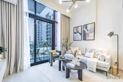 a living room with a couch and a table at Captivating 1BR Apartment in Azizi Riviera 20, Al Merkadh by Deluxe Holiday Homes in Dubai