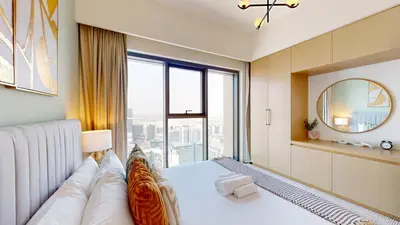 a bedroom with a large bed and a large window at Vacationer I Modern 1 Bed High-Floor Stay I City Skyline View I Burj Royale I Downtown in Dubai