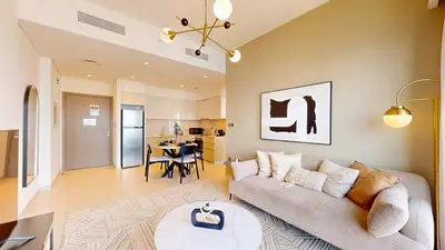 a living room with a couch and a table at Vacationer I Modern 1 Bed High-Floor Stay I City Skyline View I Burj Royale I Downtown in Dubai