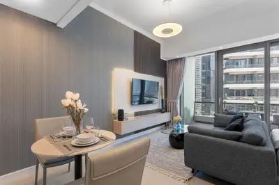 a living room with a table and a couch and a tv at Stylish Studio with Premium Features in Marina in Dubai