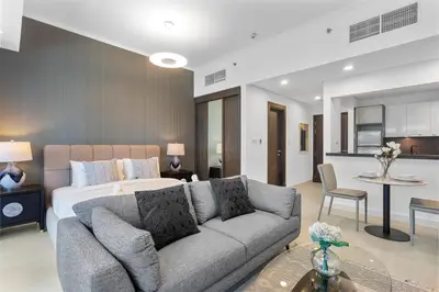 a living room with a bed and a couch at Stylish Studio with Premium Features in Marina in Dubai
