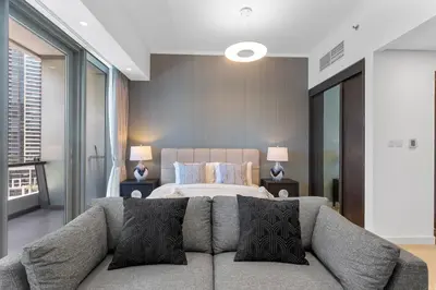 a bedroom with a bed and a couch at Stylish Studio with Premium Features in Marina in Dubai