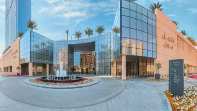 a rendering of a building with a fountain in front at Hospitality Expert 7 Palm Studio - Beach Pool Bar in Dubai