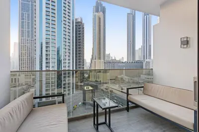 a living room with a couch and a view of a city at FIRST CLASS Studio Stylish Haven in Dubai