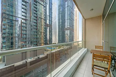 a balcony with a view of a large city at FIRST CLASS 2BR Elite Urban Retreat in Dubai