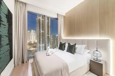 a bedroom with a large white bed and a large window at FIRST CLASS 3BR Trendy Urban Hideaway in Dubai