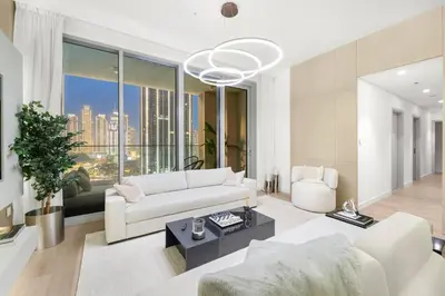 a living room with a white couch and a large window at FIRST CLASS 3BR Trendy Urban Hideaway in Dubai