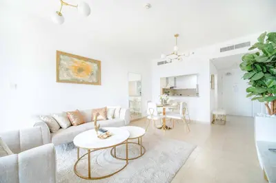 a white living room with a couch and a table at Marina Tower - Stunning 1BHK with Marina View by Elegant Escape's in Dubai