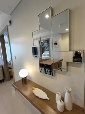 a room with a counter with a mirror and a table at Upgraded Downtown Dubai 2 BD in Dubai