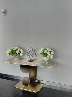 a shelf with vases and flowers on a wall at Upgraded Downtown Dubai 2 BD in Dubai