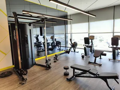 a gym with several treadmills and machines in a room at Upgraded Downtown Dubai 2 BD in Dubai