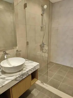 a bathroom with a sink and a glass shower at Upgraded Downtown Dubai 2 BD in Dubai