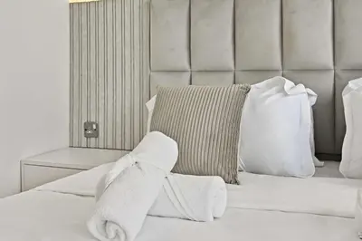a white bed with a towel on top of it at Incredible downtown location in Dubai