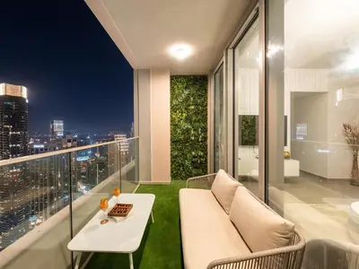 a balcony with a couch and a table and a view at Burj Khalifa Bliss I 4 bedroom Apartments I Burj Khalifa & Fountain Views I Free Gym, Pool, Parking, Wi-Fi and PS5 I by Skyline Serenity in Dubai