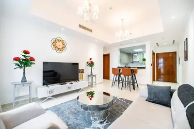 a living room with a couch and a table at Elegant Escapes - Homely 1B in Dunya Tower in Dubai