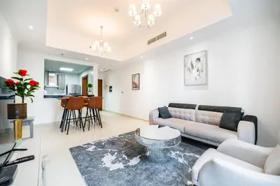 a living room with a couch and a table at Elegant Escapes - Homely 1B in Dunya Tower in Dubai