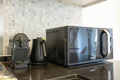 a microwave sitting on top of a kitchen counter at New Listing & Burj Khalifa View & Dubai Mall in Dubai