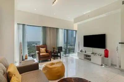 a living room with a couch and a flat screen tv at Easy access to Metro - 1BR in Central Park, DIFC - Allsopp&Allsopp in Dubai