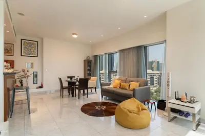 a living room with a couch and a table at Easy access to Metro - 1BR in Central Park, DIFC - Allsopp&Allsopp in Dubai
