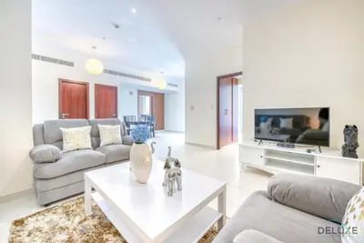 a living room with a couch and a table at Burj Khalifa Lake Vicinity Perfect 1BR Escape, Residences 7, Downtown Dubai by Deluxe Holiday Homes in Dubai