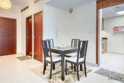a dining room with a black table and chairs at Burj Khalifa Lake Vicinity Perfect 1BR Escape, Residences 7, Downtown Dubai by Deluxe Holiday Homes in Dubai