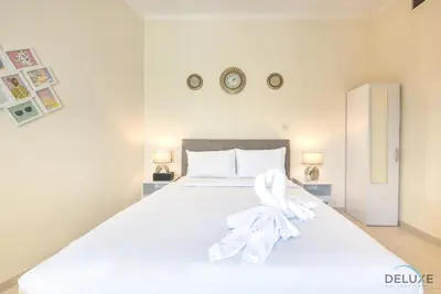 a bedroom with a white bed with towels on it at Burj Khalifa Lake Vicinity Perfect 1BR Escape, Residences 7, Downtown Dubai by Deluxe Holiday Homes in Dubai