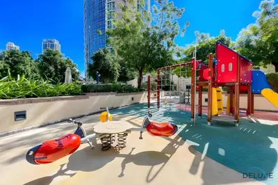 a playground in a park with a slide at Burj Khalifa Lake Vicinity Perfect 1BR Escape, Residences 7, Downtown Dubai by Deluxe Holiday Homes in Dubai