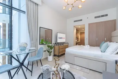 a bedroom with a bed and a desk and a table at Pool View & 2 adults 2 kids & Brand New & Czechin in Dubai