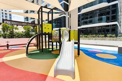 a playground in a building with a slide at Pool View & 2 adults 2 kids & Brand New & Czechin in Dubai