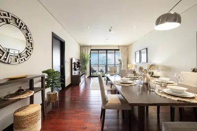 a dining room and living room with a table and chairs at Beachfront Residences with Full Sea and Burj AlArab Views in Luxury Resort in Dubai