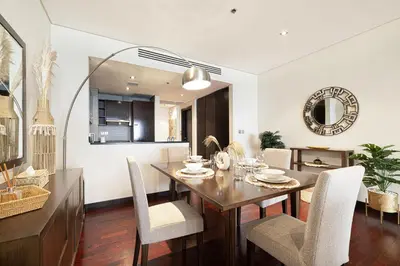 a dining room with a table and chairs at Beachfront Residences with Full Sea and Burj AlArab Views in Luxury Resort in Dubai