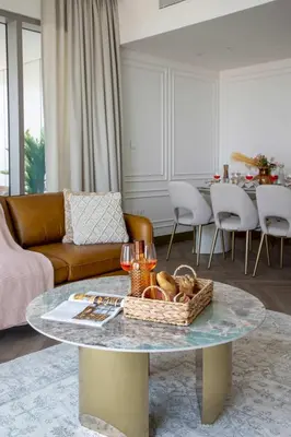 a living room with a table with a basket of bread at Frank Porter - Downtown Views II Tower 1 in Dubai