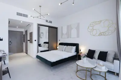 a living room with a bed and a couch at Elegant Studio in Binghatti Canal in Dubai