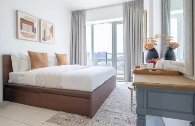a bedroom with a large bed and a window at Frank Porter - Golf Tower 3 in Dubai