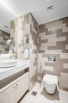 a bathroom with a toilet and a sink at Goldbest - Seven Palm 4ppl in Dubai