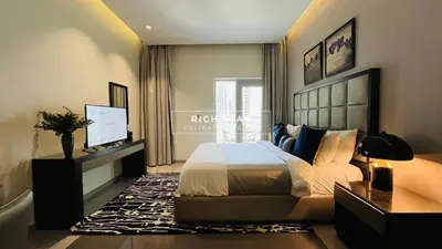 a bedroom with a bed and a television in it at Modern loft Studio in Damac Majestine,Business Bay in Dubai
