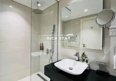 a bathroom with a sink and a shower at Modern loft Studio in Damac Majestine,Business Bay in Dubai