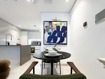 a kitchen and dining room with a table and chairs at Trophy - Elevated Living in Luxurious Business Bay Loft in Dubai