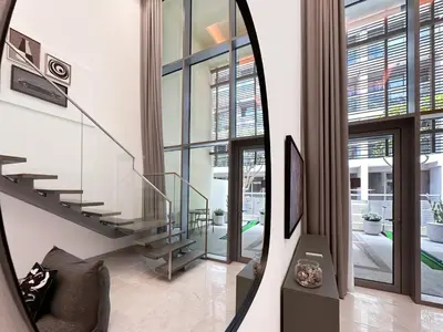 a mirror in a living room with a stairway at Trophy - Elevated Living in Luxurious Business Bay Loft in Dubai