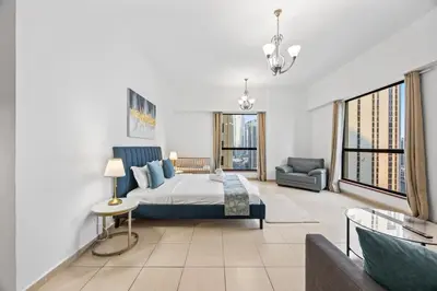 a bedroom with a king sized bed and a couch at Prime Spacious 5 Plus 1 BR Apt On JBR Beach near Metro ,Walk to The Mall, Dining & Entertainment - By Sunkissed Holiday Homes in Dubai