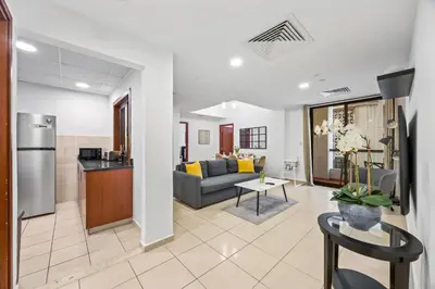 a living room with a couch and a table at Prime Spacious 5 Plus 1 BR Apt On JBR Beach near Metro ,Walk to The Mall, Dining & Entertainment - By Sunkissed Holiday Homes in Dubai