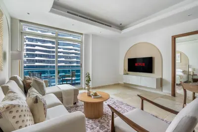 a living room with white furniture and a fireplace at GuestReady - Stunning hideaway in Dubai Marina in Dubai